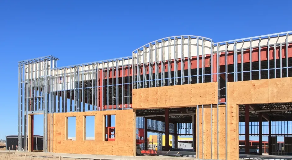 A large building under construction with a blue sky in the background.